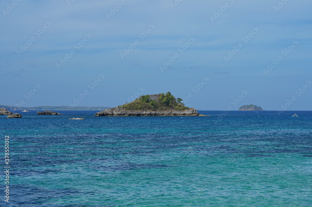 Rocky island with trees in the sea.