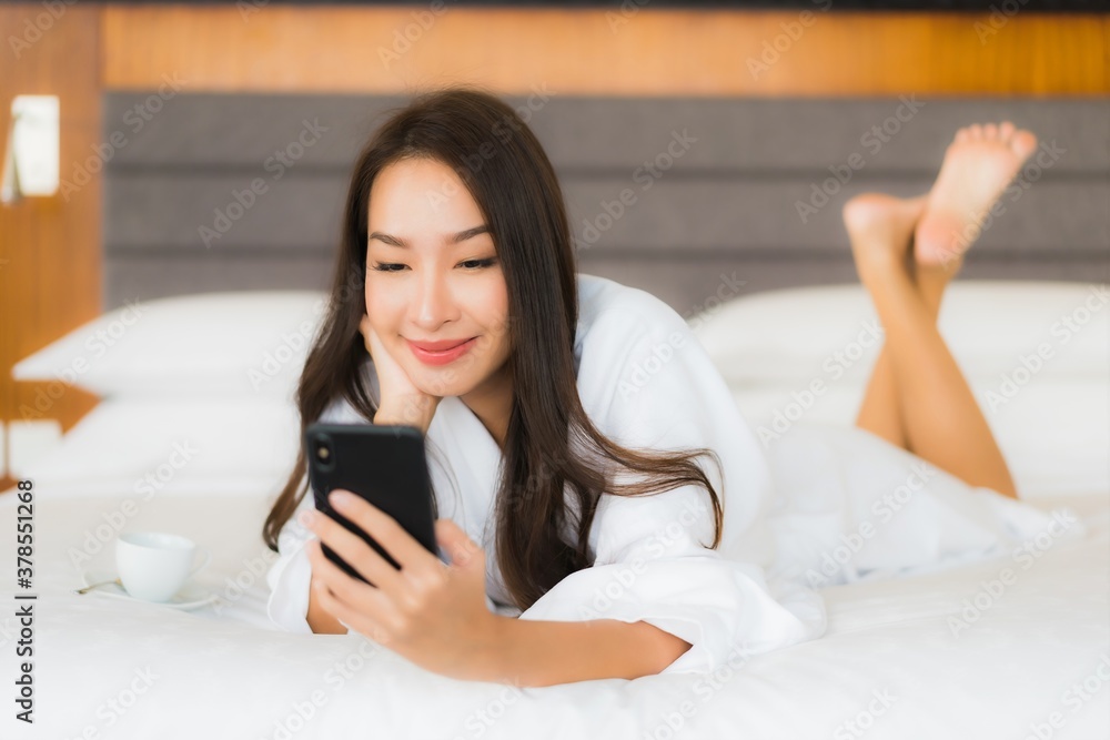 Portrait beautiful young asian woman use smart mobile phone on bed Portrait beautiful young asian woman use smart mobile phone on bed