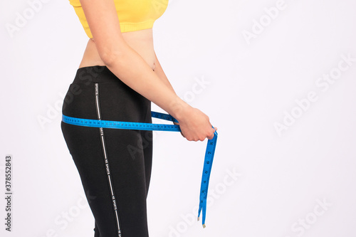 girl measures her waist and hips