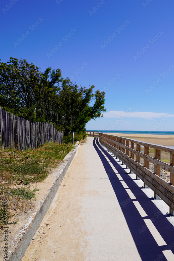 wooden pathway access french sea coast with sunny atlantic beach in summer day