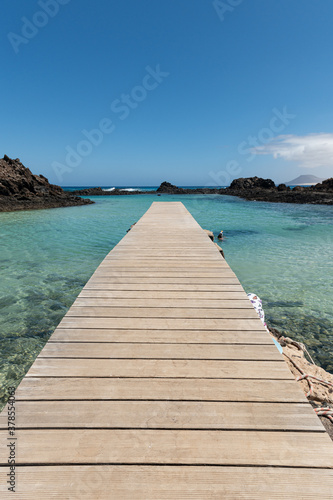 Wooden pier in  Isla de Lobos, Canary Islands, Spain. © acongar