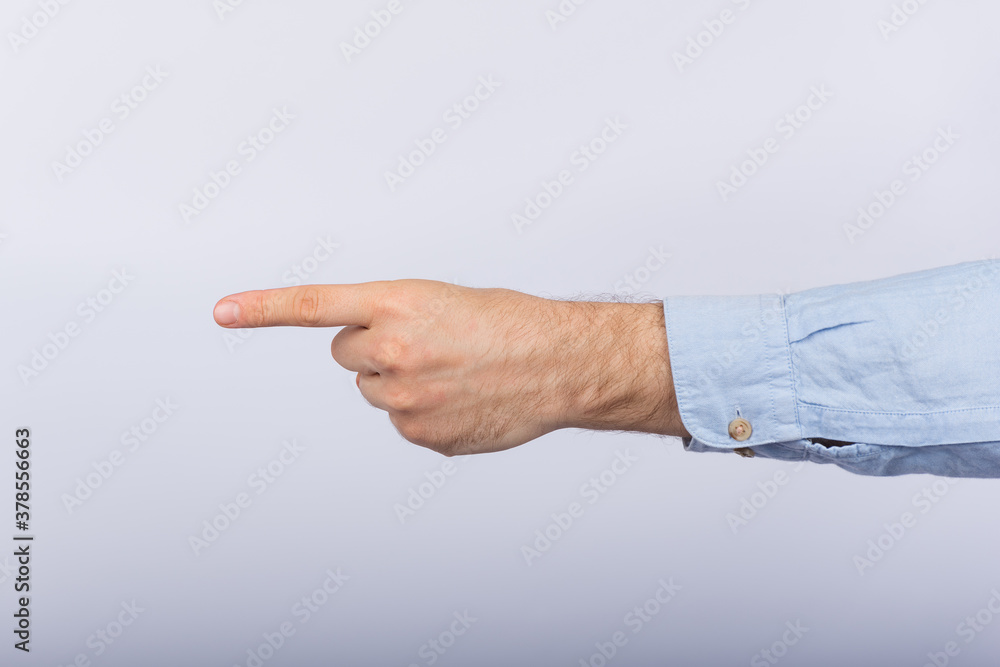 Male hand shows direction of index finger. Pointing hand on white background.