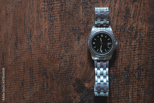 .Stainless steel watch on wooden background