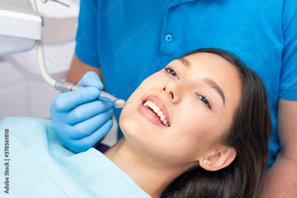 Fototapeta premium Dentist and patient in the dental office. Woman having teeth examined by dentists