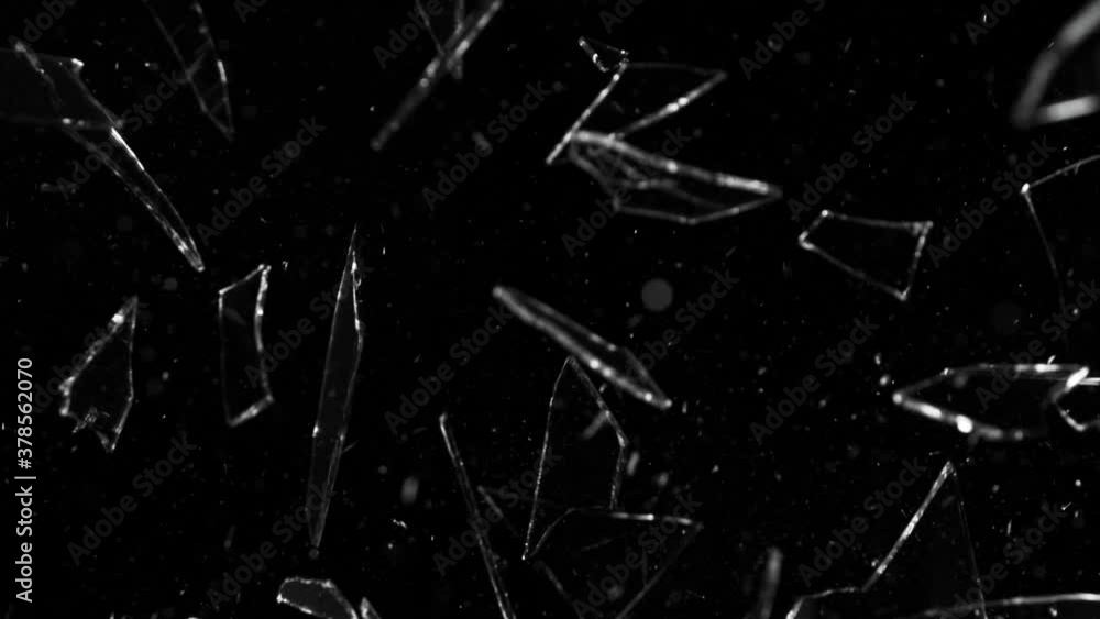 Super slow motion of shattered glass on black background. Filmed on high speed cinema camera, 1000 fps. Super slow motion of shattered glass on black background. Filmed on high speed cinema camera, 1000 fps.