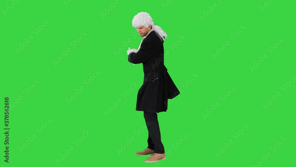 A man dressed as a courtier doing nothing and waving hands on a Green Screen, Chroma Key. A man dressed as a courtier doing nothing and waving hands on a Green Screen, Chroma Key.