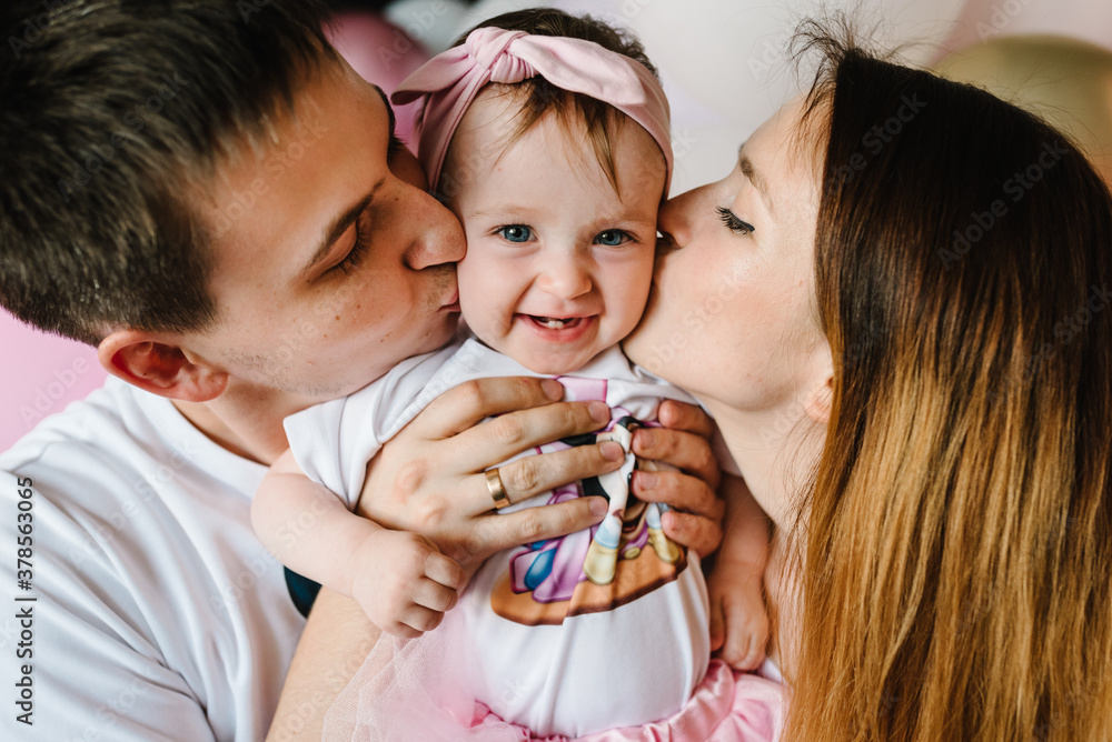 Happy family with balloons. Mother, father hugging daughter. Birthday ...
