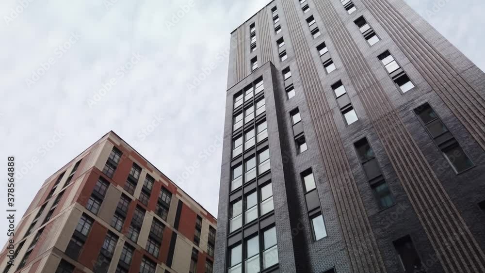 Exterior of a high-rise multi-story apartment building - facade, windows and balconies. Exterior of a high-rise multi-story apartment building - facade, windows and balconies.