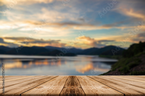 Showcase an old wooden table shelf on a beautiful sunset and blurred nature background.