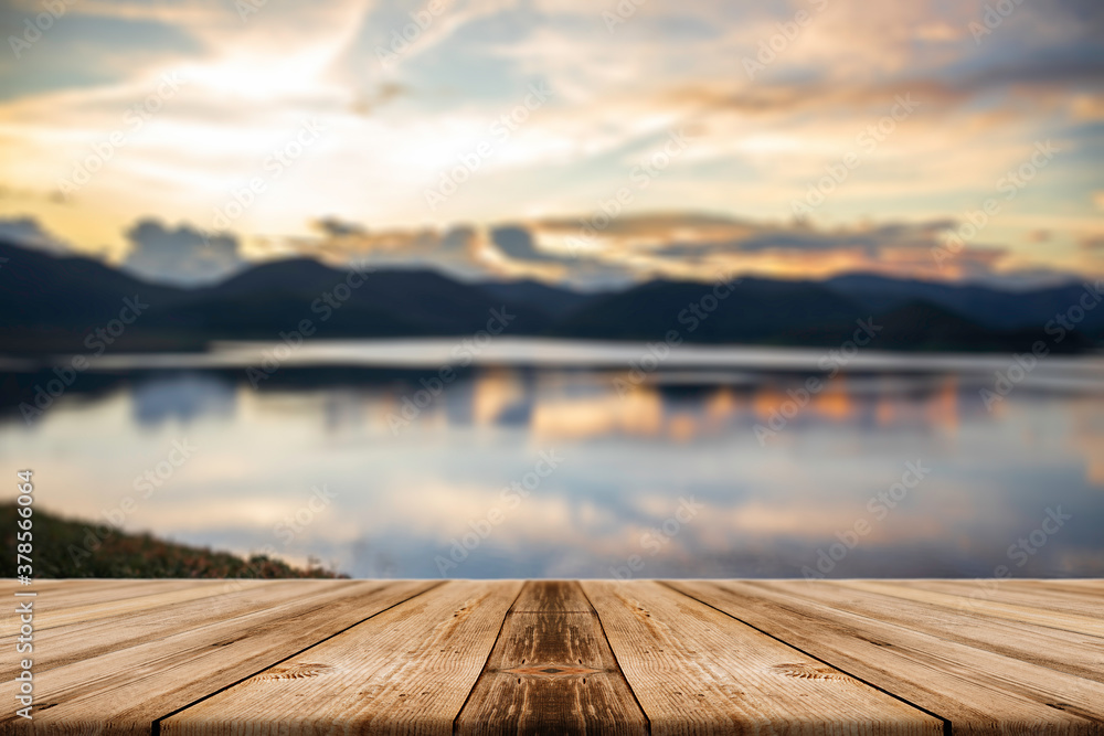 Showcase an old wooden table shelf on a beautiful sunset and blurred nature background.