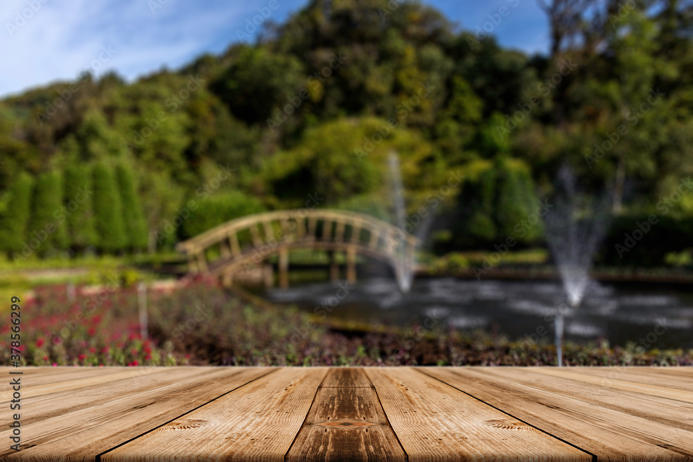 Showcase old wooden table shelves in the park and beautiful blurred nature background. Showcase old wooden table shelves in the park and beautiful blurred nature background.
