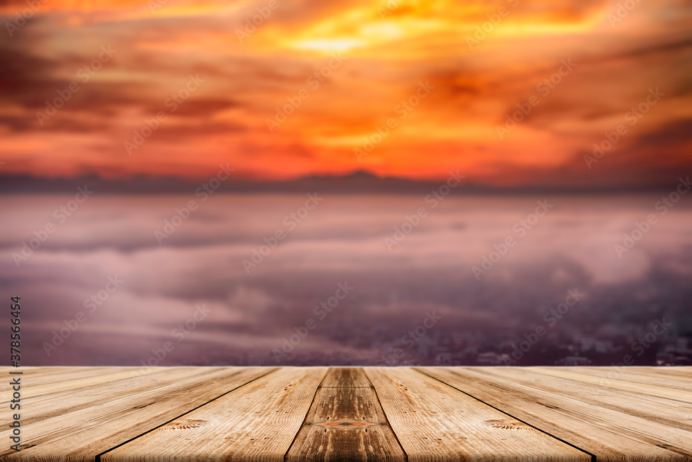 Showcase an old wooden table shelf over a beautiful sunrise and blurred nature background.