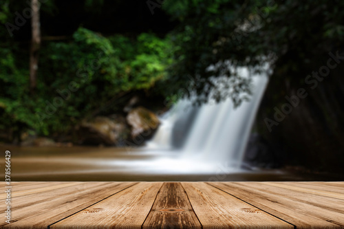 The empty wooden table above the waterfall view.