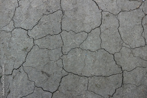 Dried up cracked gray soil 