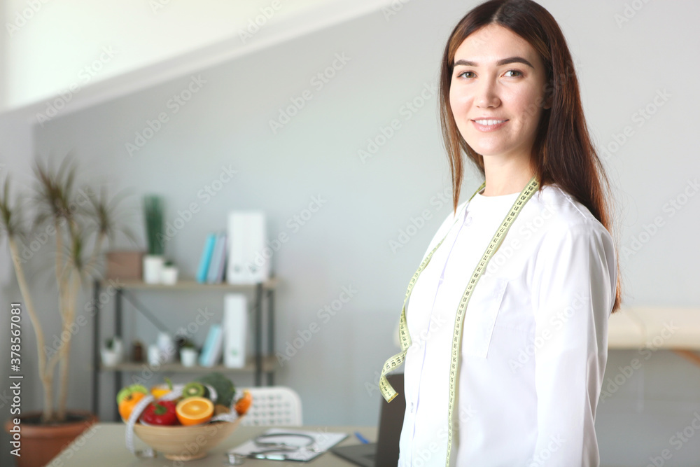 young doctor nutritionist in his office demonstrates the concept of healthy eating. Help with weight control young doctor nutritionist in his office demonstrates the concept of healthy eating. Help with weight control