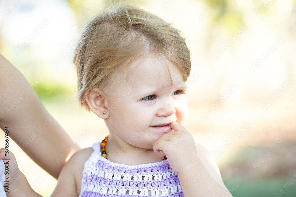 Blue eyed blonde baby with finger in mouth. Blue eyed blonde baby with finger in mouth.
