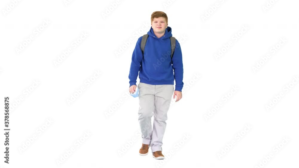Teenager walking and taking off medical mask on white background. Teenager walking and taking off medical mask on white background.