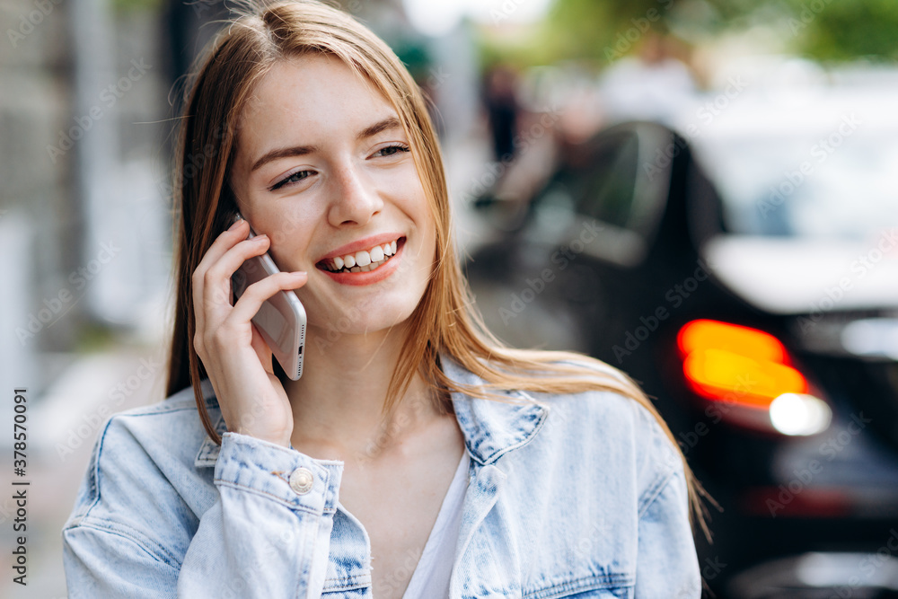 Pretty girl on a noisy street background talking on the phone Pretty girl on a noisy street background talking on the phone