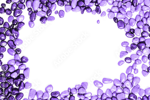 frame made of stones on a white background. beautiful purple pebbles in water drops. space for text, flat lay