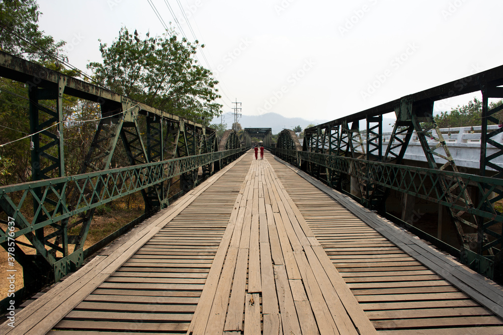 Thai people and foreign travelers travel visit and walking take photo on Tha Pai Memorial Bridge or Tha Pai World War II Memorial at Pai city valley hill in Mae Hong Son, Thailand