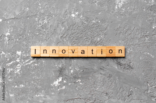 INNOVATION word written on wood block. INNOVATION text on table, concept
