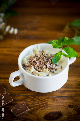 sweet noodles with milk and grated chocolate in a bowl