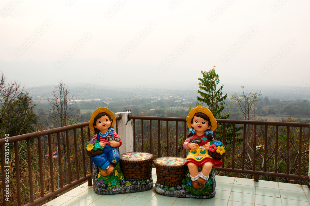 Boy and girl toy stone statue in garden outdoor at viewpoint of Phra That Mae Yen Temple at Pai city on February 26, 2020 in Mae Hong Son, Thailand
