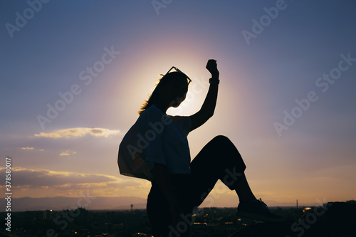 Happy free woman posing at sunshine. Active and positive concept.