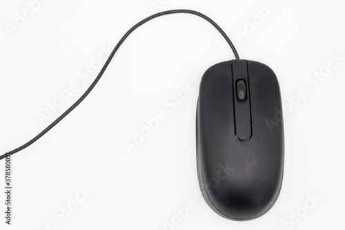 Top view of a black computer mouse with wheel and wire on white background. Flat lay with space for text