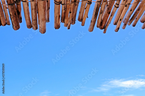 Wooden roof and blue sky background.