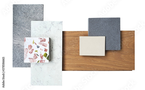 top view of interior material board. combination of white marble ,grey slate stone ,terazzo stone ,grey and beige artificial stone ,engineer wood flooring samples isolated on white background. photo