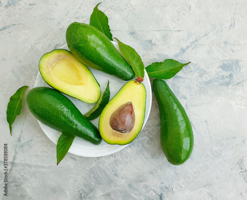 fresh avocado in a plate on concrete background
