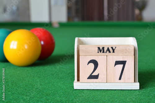 May 27, number cube with balls on snooker table, sport background. photo