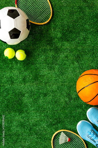 Flat lay of sport balls - football  basketball on grass top view copy space