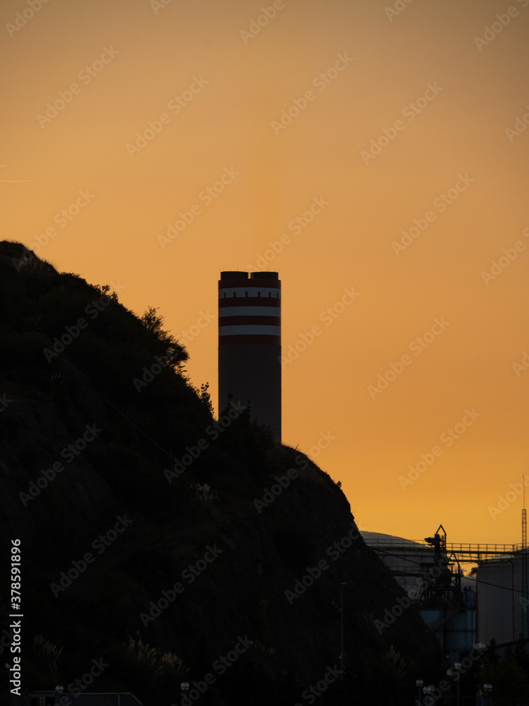 industrial warehouse at sunset next to a port industrial warehouse at sunset next to a port