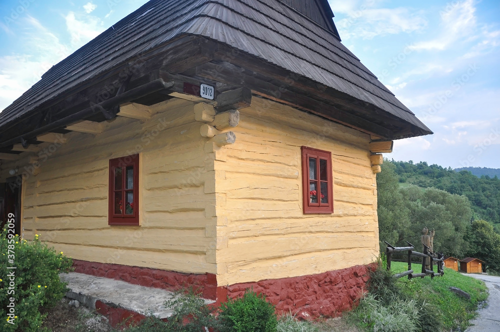 VLKOLINEC, SLOVAKIA, EUROPE, SUMMER 2015. Beautiful rural house with traditional Slovak vanilla painted wooden architecture in the Unesco heritage village of Vlkolinec.