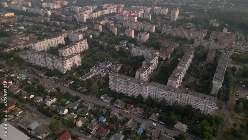 Drone flying over apartment buildings and street in small European city at summer evening Drone flying over apartment buildings and street in small European city at summer evening