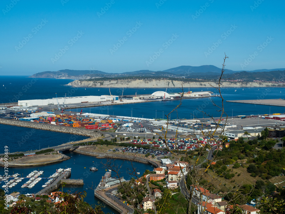 port of bilbao with ships and containers. you can see some industry and the sea as well as boats