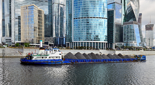 Barge with cargo floats along Moscow River past Moscow International Business Center (MIBC)