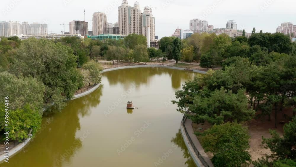 Aerial view. Victory park in Odessa, Ukraine. City park with green trees and water in a pond on the background of buildings on a summer day Aerial view. Victory park in Odessa, Ukraine. City park with green trees and water in a pond on the background of buildings on a summer day