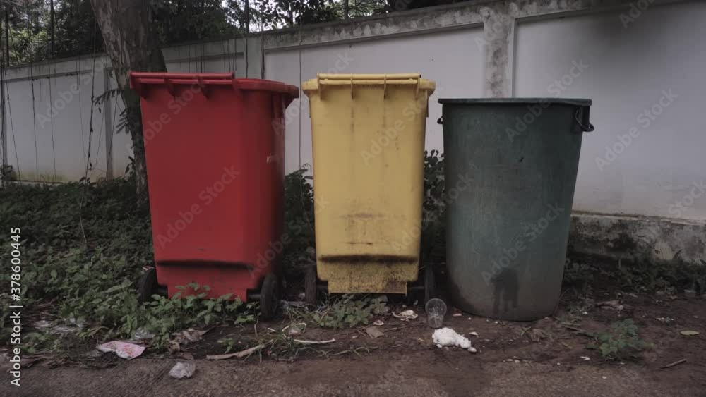 Red, green, yellow trash in the community Red, green, yellow trash in the community