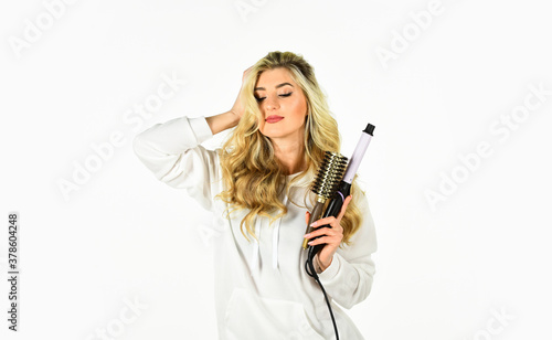 we make it a reality. beauty face. Hairdressing salon Concept. Healthy Long Blond Hair. woman curling long hair using curling iron. beauty and fashion. Hairstyle wavy curls. Perfect make up and curls