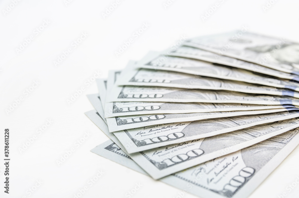 Beautifully folded hundred dollar bills. White wooden background. Copy of space. Beautifully folded hundred dollar bills. White wooden background. Copy of space.