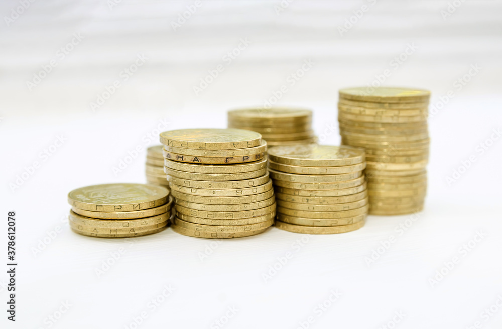 several stacks of coins on a light background. Saving concept. several stacks of coins on a light background. Saving concept.