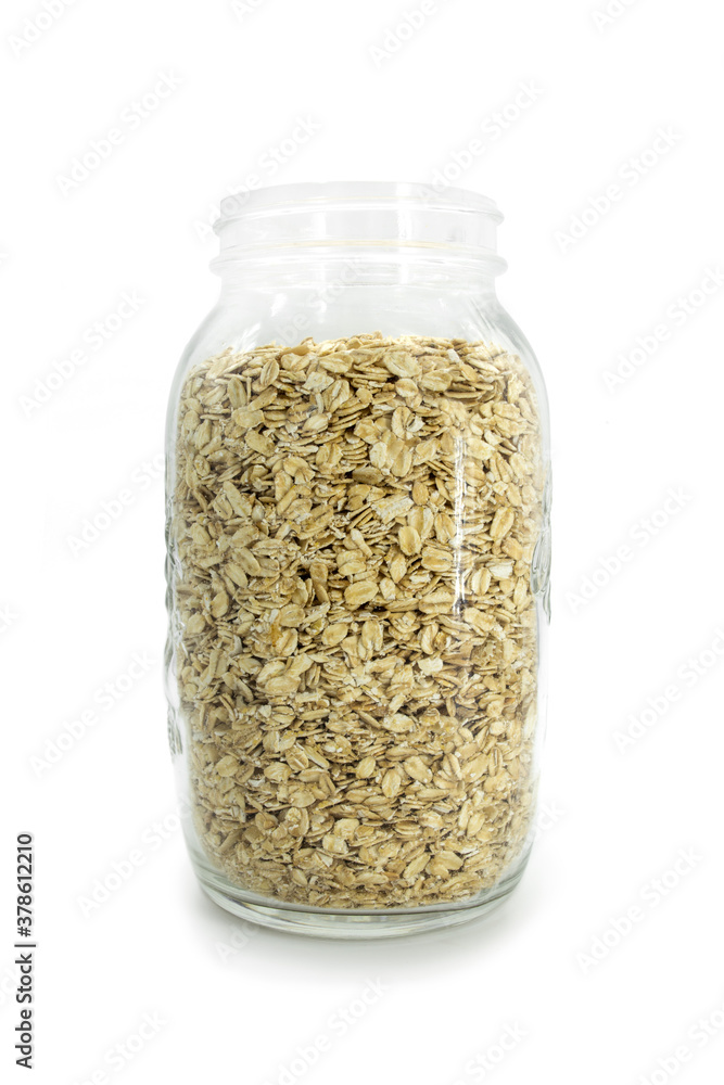 Glass jar full of natural oats, isolated on white background. Glass jar full of natural oats, isolated on white background.