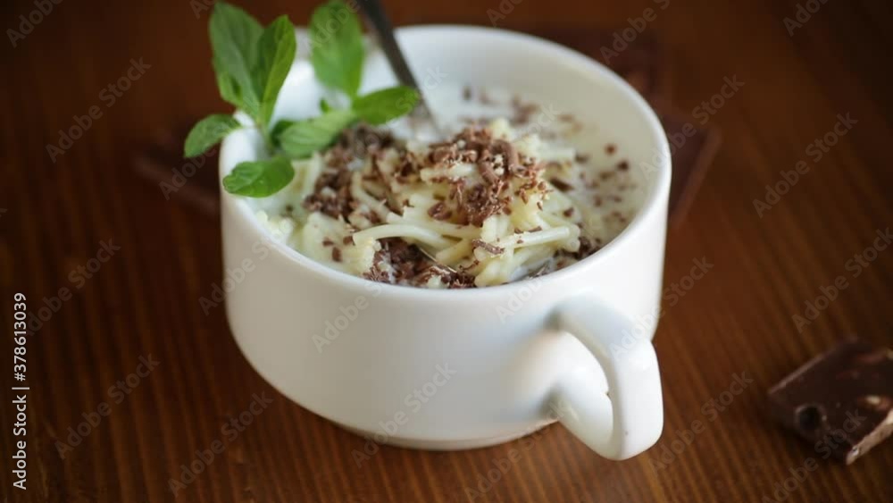 sweet noodles with milk and grated chocolate in a bowl sweet noodles with milk and grated chocolate in a bowl