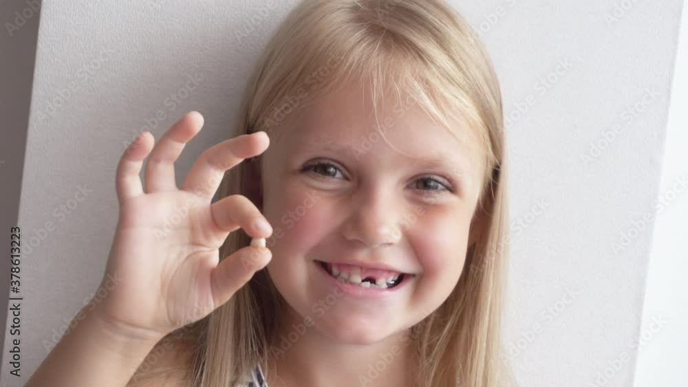 Little cute child girl portrait smile without one front milk tooth Little cute child girl portrait smile without one front milk tooth