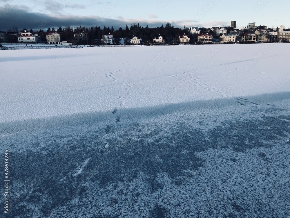 Footprints on Frozen Lake Tjrnin, Reykjavik, Iceland
