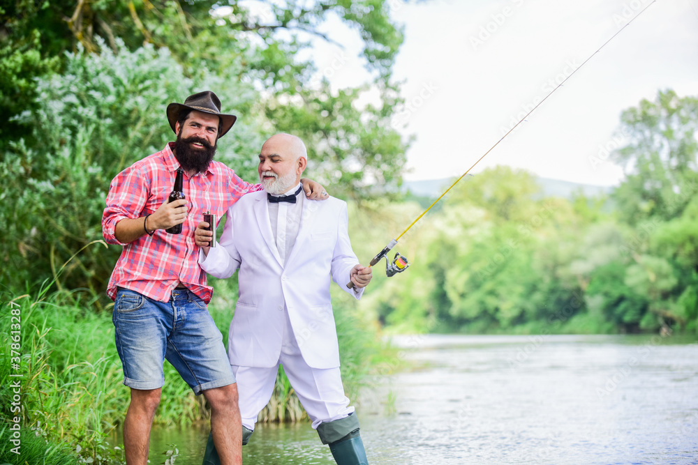 outdoor picnic. summer family weekend. father and son fishing. mature man fisher celebrate retirement. two fishermen with fishing rods. hobby and sport activity. retired businessman. male friendship outdoor picnic. summer family weekend. father and son fishing. mature man fisher celebrate retirement. two fishermen with fishing rods. hobby and sport activity. retired businessman. male friendship