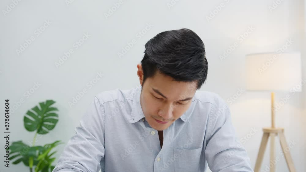 Asia businessman social distancing in new normal situation for virus prevention looking at camera presentation to colleague about plan in video call while work in office. Lifestyle after corona virus. Asia businessman social distancing in new normal situation for virus prevention looking at camera presentation to colleague about plan in video call while work in office. Lifestyle after corona virus.